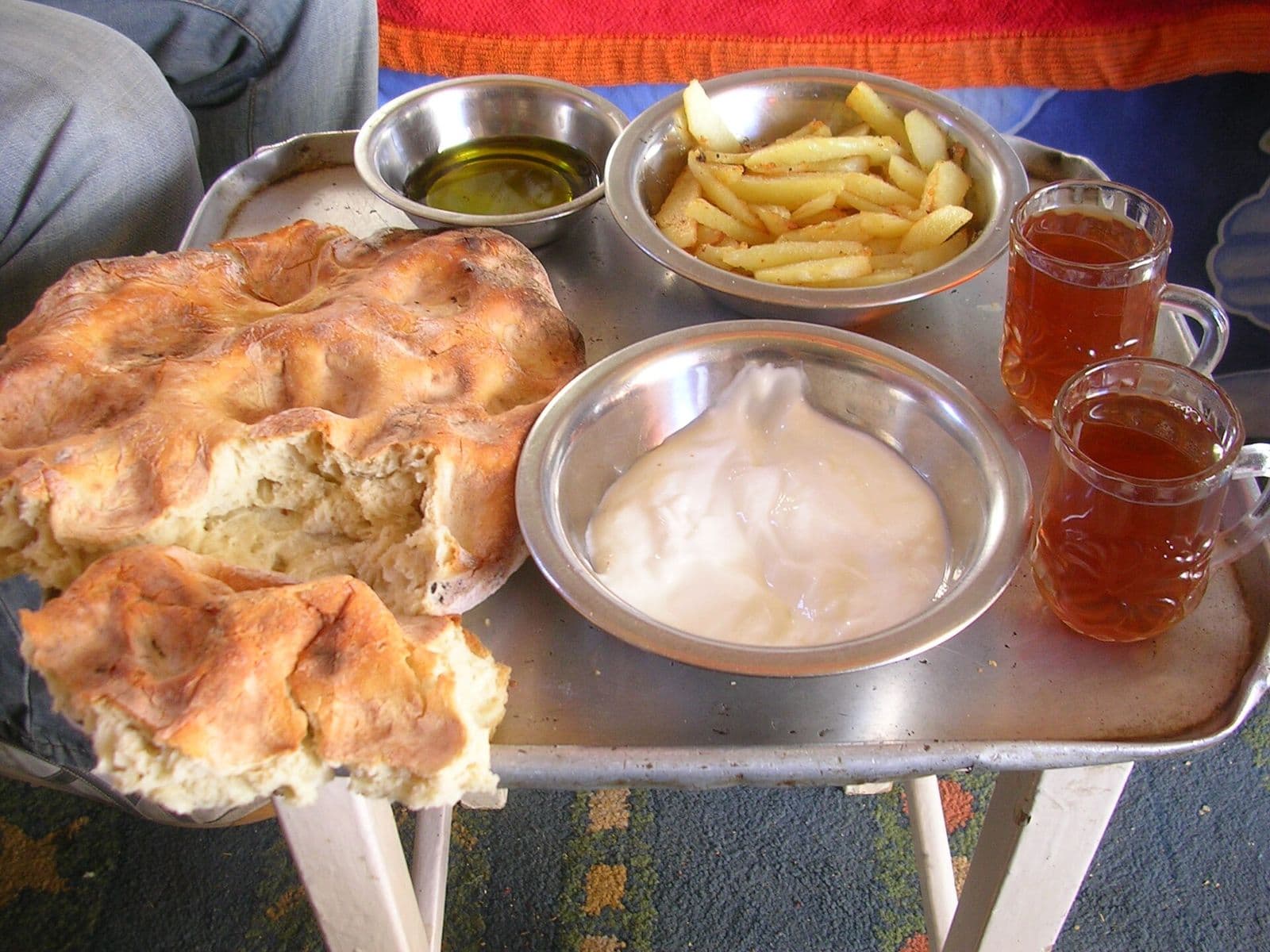 Levantine breakfast tray with labneh, olive oil, fresh flatbread and tea