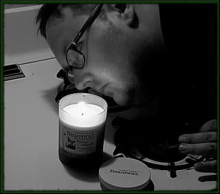 Lit candle in a glass jar